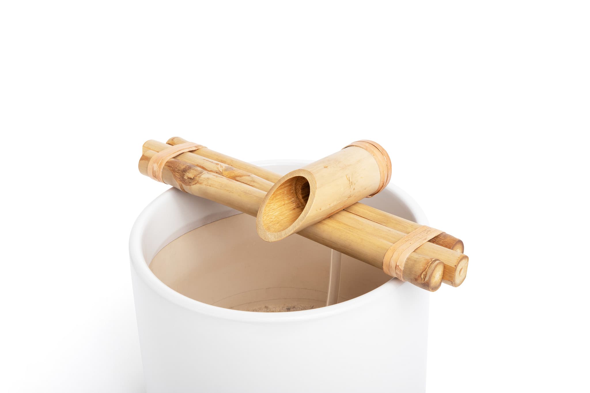 Bamboo fountain on white ceramic pot